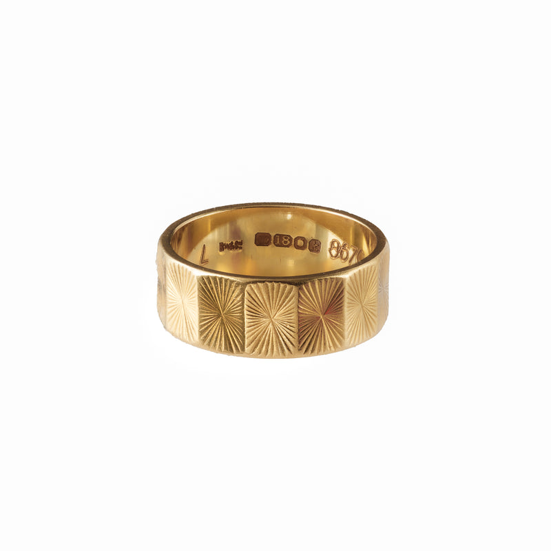 Antique gold ring with geometric sunburst pattern