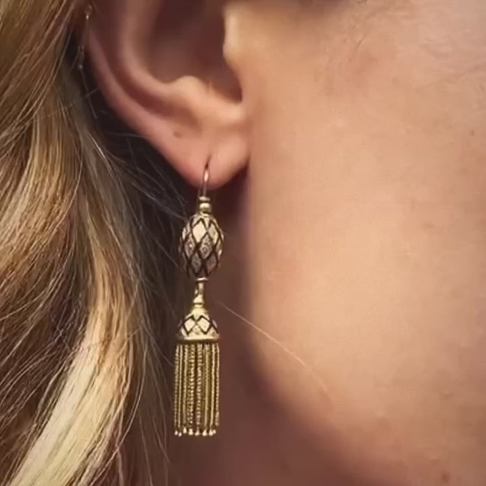 Antique French gold tassel earring with cobalt blue enamel detail, worn on ear; c.1880, 18ct yellow gold with fine chain fringe.