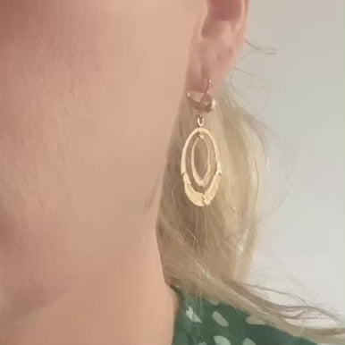 Model wearing antique Italian double-hoop earrings with hand-engraved botanical motifs in yellow and white gold