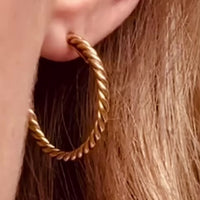 Cartier 18ct gold rope hoop earring worn on ear