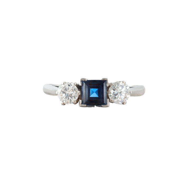 Vintage 1940s platinum ring set with a square blue sapphire and two round brilliant diamonds, classic three stone design made in England.