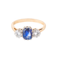 Mid century three stone ring c.1950s, set with a 1.25ct Sri Lankan sapphire and 0.50ct VS2 diamonds in 18ct gold with platinum head, shown from the front.