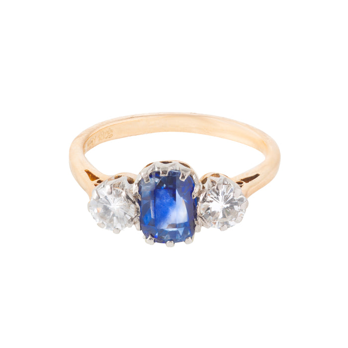 Mid century three stone ring c.1950s, set with a 1.25ct Sri Lankan sapphire and 0.50ct VS2 diamonds in 18ct gold with platinum head, shown from the front.