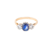 Mid century three stone ring c.1950s, set with a 1.25ct Sri Lankan sapphire and 0.50ct VS2 diamonds in 18ct gold with platinum head, shown from the front.