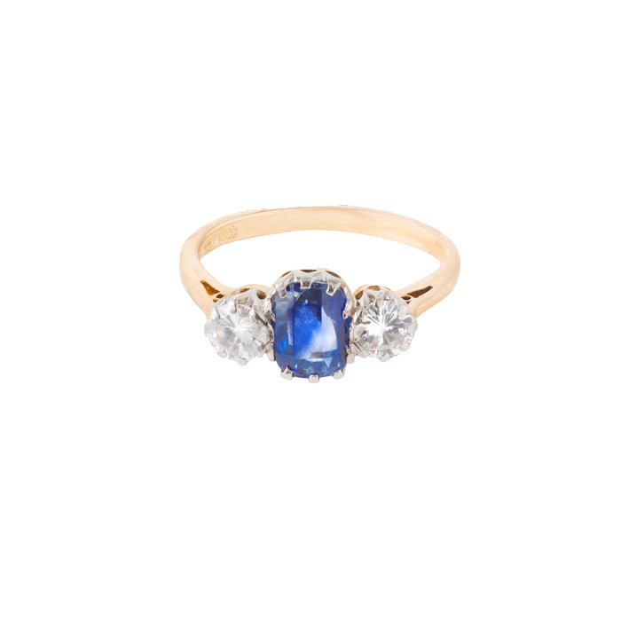 Mid century three stone ring c.1950s, set with a 1.25ct Sri Lankan sapphire and 0.50ct VS2 diamonds in 18ct gold with platinum head, shown from the front.