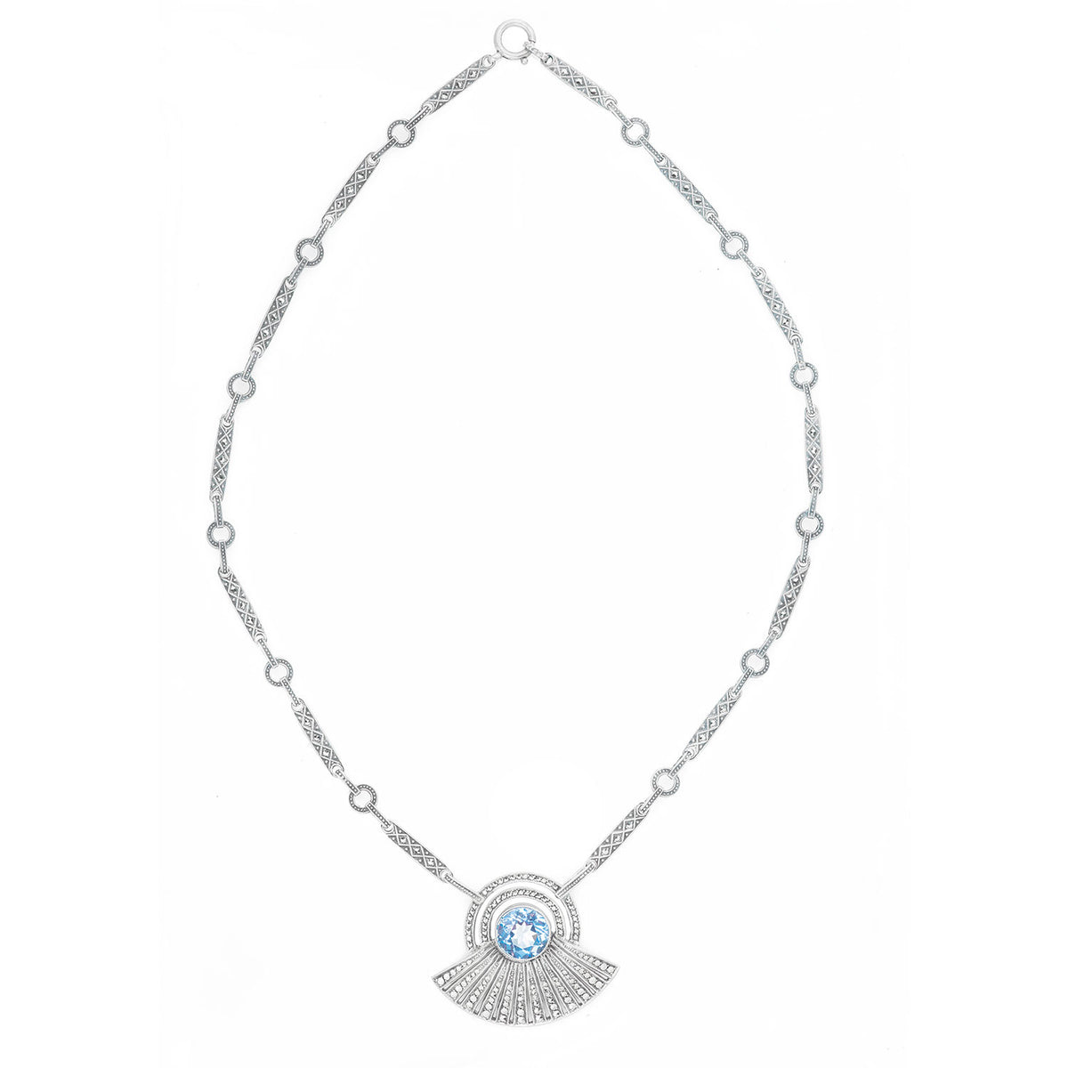 Theodor Fahrner Art Deco silver necklace from the 1930s, featuring a round blue spinel in a marcasite radiating fan design, shown on display.