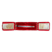 Vintage 9ct gold sapphire and diamond bangle, English c.1970s, shown in a red display box, front view.