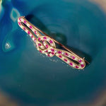 A Ruby Pearl Love Knot brooch