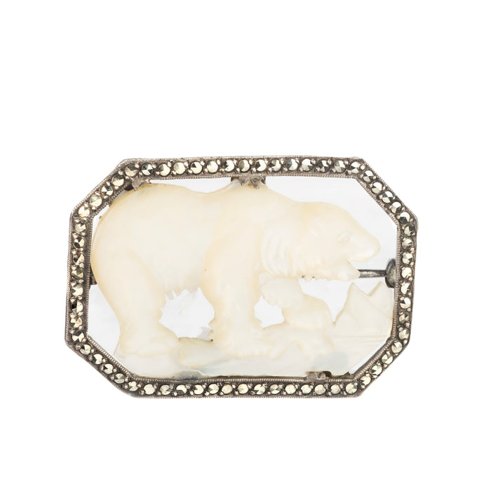 Antique 1920s silver brooch featuring a mother of pearl polar bear with marcasite frame