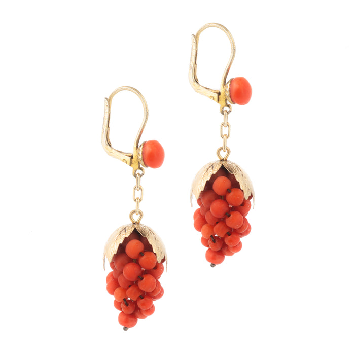 Side view of Italian coral earrings with silver gilt leaves and lever backs