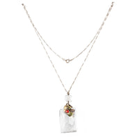 Full view of a Dorrie Nossiter pendant necklace, showcasing a faceted rock crystal drop with clustered gemstones in an ornate setting.