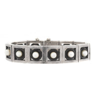 Close-up of Mexican silver bracelet with pearls, marked Antonio crown hallmark