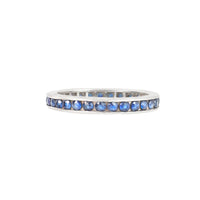 Side profile of vintage 18ct yellow gold eternity ring showcasing channel-set sapphires.