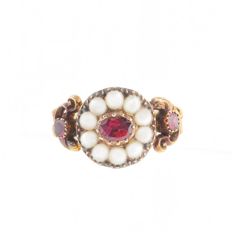 Georgian 15ct gold ring with central garnet and natural pearl cluster, scrolled shoulders and garnet side stones, c.1780.