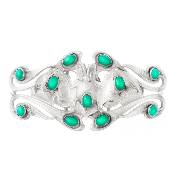 Sterling silver Art Nouveau belt buckle featuring a bat motif with chrysoprase cabochons, circa 1920.